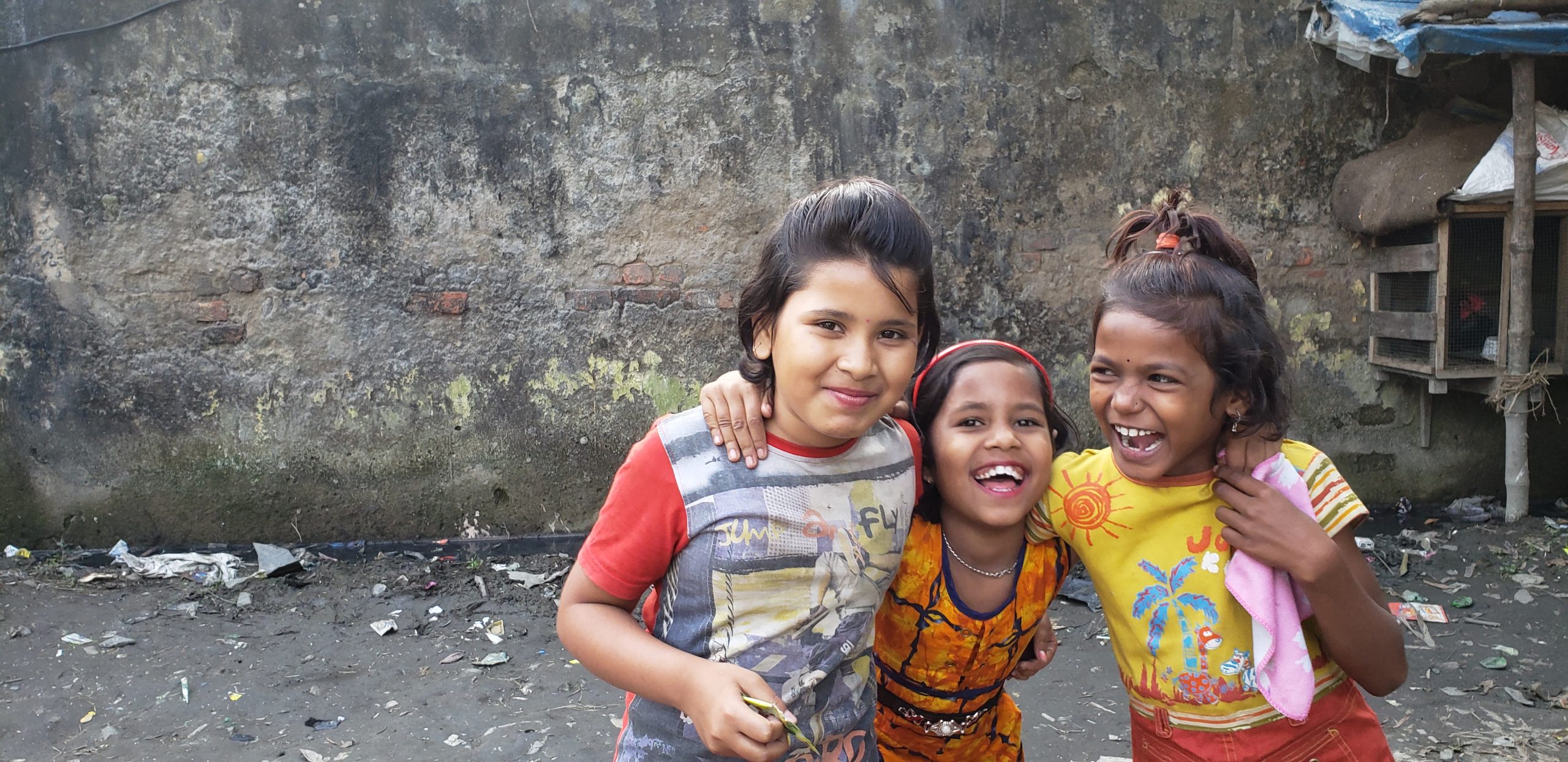three young girls laughing in India